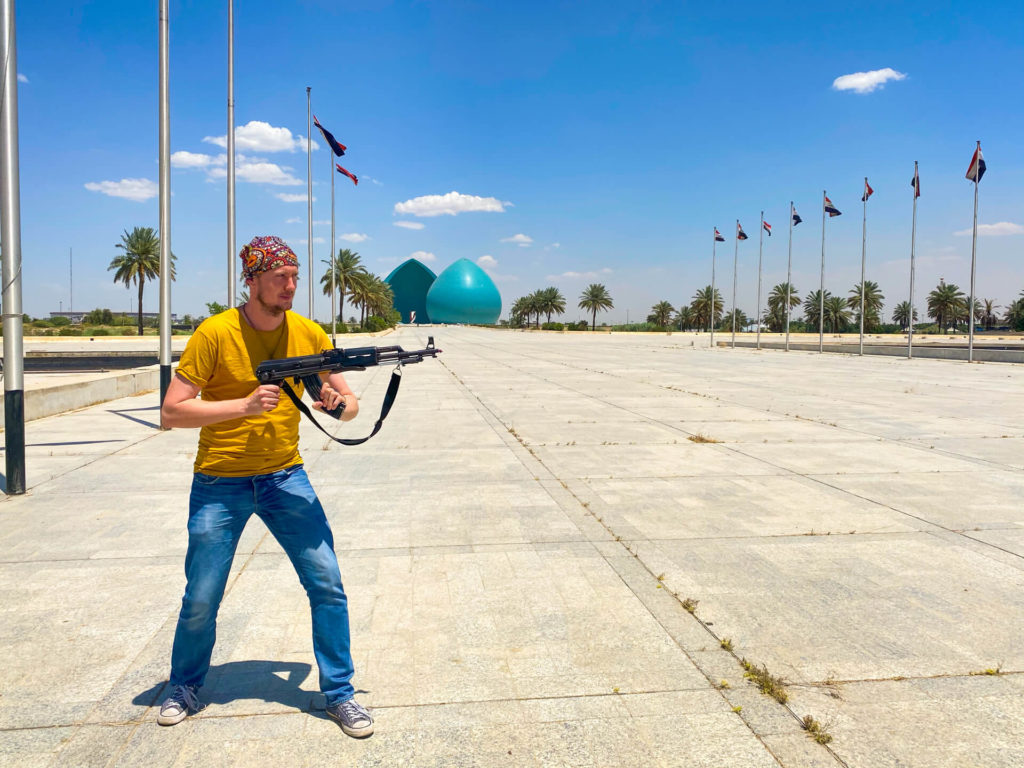 Me holding a Kalashnikov in front of the Martyr's Monument in Baghdad.