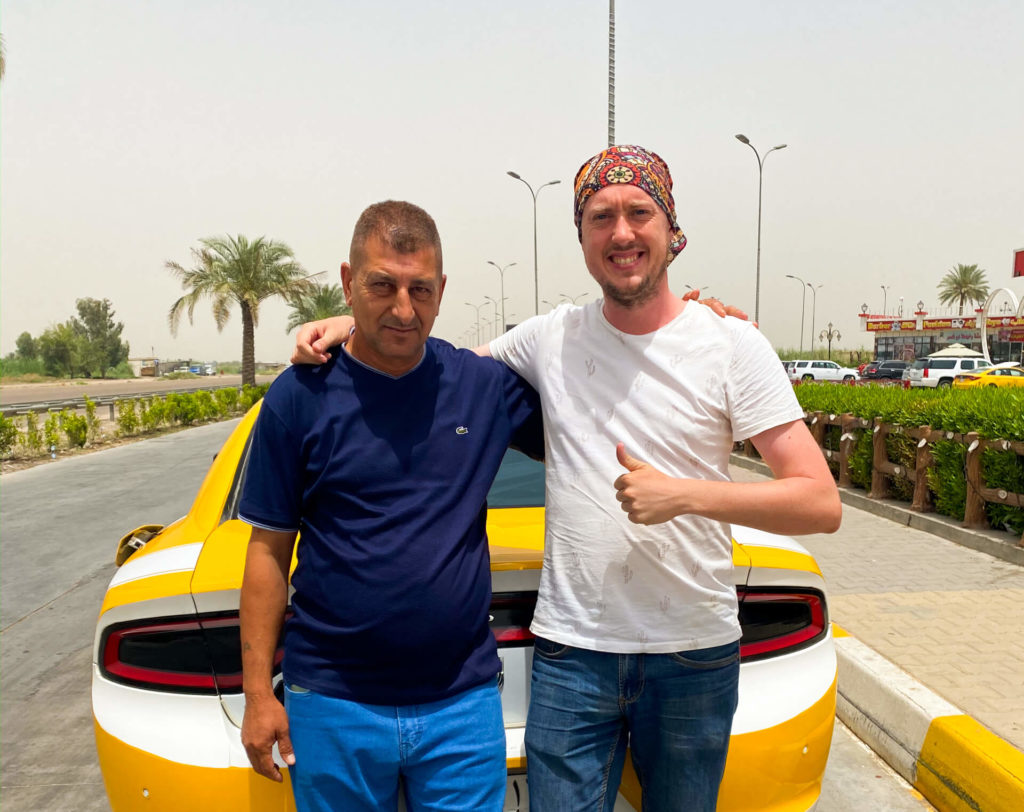 Me and an Iraqi taxi driver posing in front of his taxi
