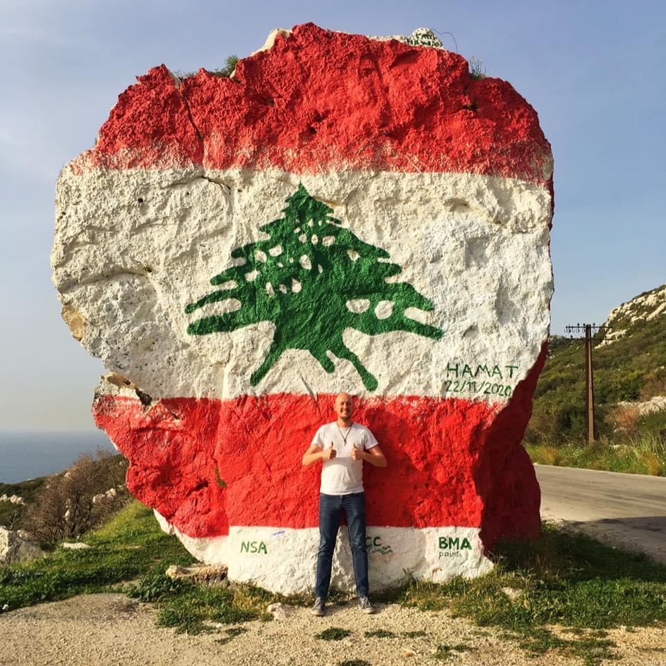 Me, standing in front of the Rock of Hamat, which has been painted in the colours of the Lebanese flag.