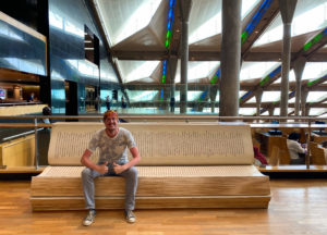 Me, sitting on a bench shaped like a book in the modern Library of Alexandria.