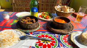 An Egyptian meal with stewed camel and a Stella beer.