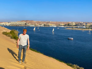 Me, hiking up a huge bank of sand by the River Nile with Aswan in the background.